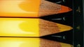 Crayons in yellow gradient row. Extreme macro shot. Pencils graphite set.