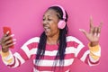 Crazy african senior woman listening music on mobile phone app - Focus on face Royalty Free Stock Photo