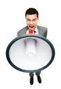 Crazy Asian businessman screaming in megaphone on white background