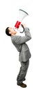 Crazy Asian businessman screaming in megaphone on white background