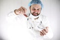 Crazy bearded doctor in a white coat and old syringe Royalty Free Stock Photo