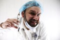 Crazy bearded doctor in a white coat and old syringe Royalty Free Stock Photo