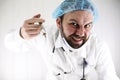 Crazy bearded doctor in a white coat and old syringe Royalty Free Stock Photo