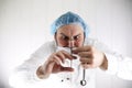 Crazy bearded doctor in a white coat and old syringe Royalty Free Stock Photo