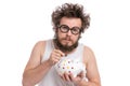 Crazy bearded man with piggy bank Royalty Free Stock Photo