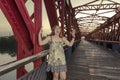 Crazy beautiful woman screaming on the red bridge over.