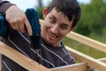 Crazy Builder screws wooden beams on the roof with a cordless screwdriver. Royalty Free Stock Photo