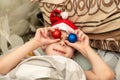 Crazy Christmas. A boy in a Santa hat lies in bed with Christmas decorations and indulges