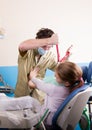 Crazy dentist treats teeth of the unfortunate patient. The patient is terrified.