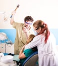 Crazy dentist treats teeth of the unfortunate patient. The patient is terrified.