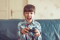 Crazy dependent kid shouting while playing video game Royalty Free Stock Photo