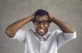 Young black man stressing out overwhelmed with anger and various negative emotions Royalty Free Stock Photo