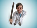 Crazy doctor holds saw in hand and laughting Royalty Free Stock Photo