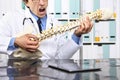 Crazy doctor with the spine skeleton pretends to play guitar