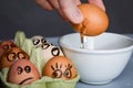 Crazy eggs terrified, Scared faces staring from egg tray at broken egg. Funny easter stories.