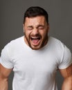 Portrait of screaming man over grey background Royalty Free Stock Photo