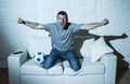 Crazy football fan watching tv soccer match alone screaming happy celebrating goal Royalty Free Stock Photo