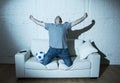 Crazy football fan watching tv soccer match alone screaming happy celebrating goal Royalty Free Stock Photo