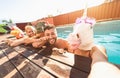 Crazy friends selfie doing pool party wearing bizarre mask - Young people having fun celebrating summer in tropical resort Royalty Free Stock Photo