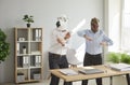 Crazy, funny office workers in horse and dinosaur masks having party at end of work day Royalty Free Stock Photo