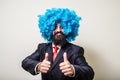 Crazy funny bearded man with blue wig