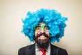 Crazy funny bearded man with blue wig