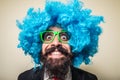 Crazy funny bearded man with blue wig