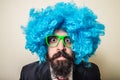 Crazy funny bearded man with blue wig