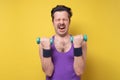 Crazy funny man try to lift small blue dambbell Royalty Free Stock Photo