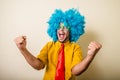 Crazy funny young man with blue wig