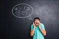 Crazy furious man yelling over blackboard background with speech bubble Royalty Free Stock Photo