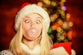 Crazy grimace. Blow Bubbles with Gum. Only fun on my mind. Girl Santa claus making big bubble with gum. Funny face close Royalty Free Stock Photo