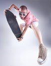 Crazy guy jumping with a skateboard making funny faces Royalty Free Stock Photo