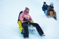 Crazy happy friends having fun with sledding on snow high mountains - Young people making luge competition at white week vacation