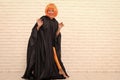 Crazy is her name. Crazy girl smiling on white brickwall. Party girl with crazy look. Fashion girl with orange wig hair