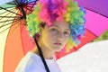 Crazy hipster girl. fashion girl with colorful hair wig and umbrella. kid in summer camp. happy youth party. autumn