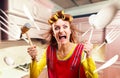 Crazy housewife in apron cooking, cookware flying Royalty Free Stock Photo