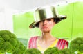 Crazy housewife in apron with a pot on her head Royalty Free Stock Photo