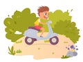 Crazy kid riding fast motor scooter on road, funny country road racing of happy boy Royalty Free Stock Photo