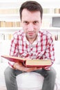 Crazy male student or professor with book in hands