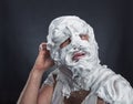 Crazy man with face completely in shaving foam