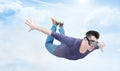 Crazy man in goggles is flying in the cloudy sky. Jumper concept Royalty Free Stock Photo