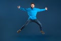 Crazy Offer. Funny Young Man Jumping Like A Star Over Blue Background Royalty Free Stock Photo