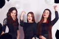 Crazy party time of three beautiful stylish women in elegant evening casual black dress celebrating , having fun, dancing Royalty Free Stock Photo