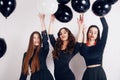 Crazy party time of three beautiful stylish women in elegant evening casual black dress celebrating , having fun, dancing Royalty Free Stock Photo