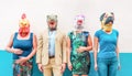 Crazy people wearing chicken, unicorn, dog and t-rex party mask - Trendy people having fun together - Bizarre and funny trend Royalty Free Stock Photo