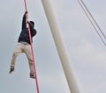 Crazy person climbing a suspension bridge