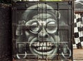 Crazy pilot portrait graffiti on rusty metal surface of garage