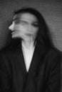 Crazy portrait of girl with mental disorders and split personality. Black and white with added grain and motion blur Royalty Free Stock Photo