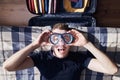 Crazy portrait of happy young man during packing suitcase Royalty Free Stock Photo